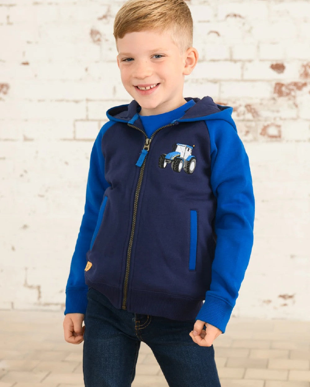 Blue Tractor coloured Lighthouse Jackson Childrens Full Zip Hoodie on wall background