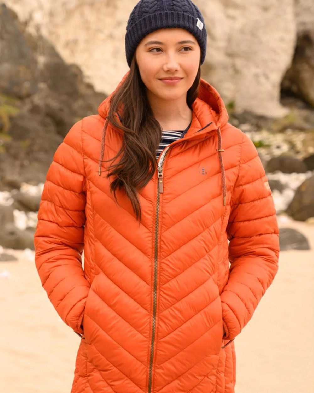 Burnt Orange coloured Lighthouse Laurel Ladies Coat on beach background