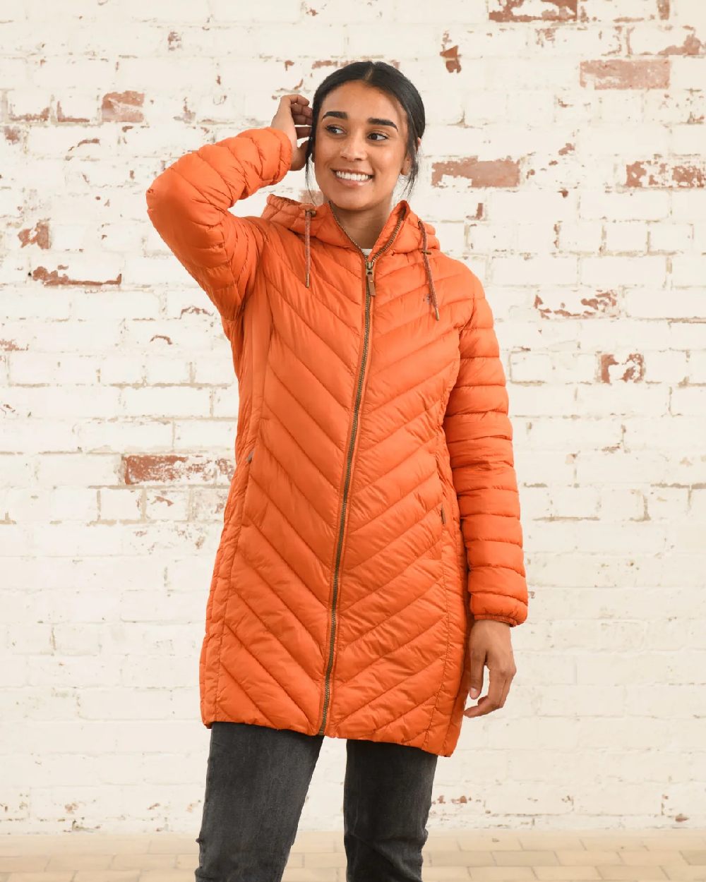 Burnt Orange coloured Lighthouse Laurel Ladies Coat on wall background