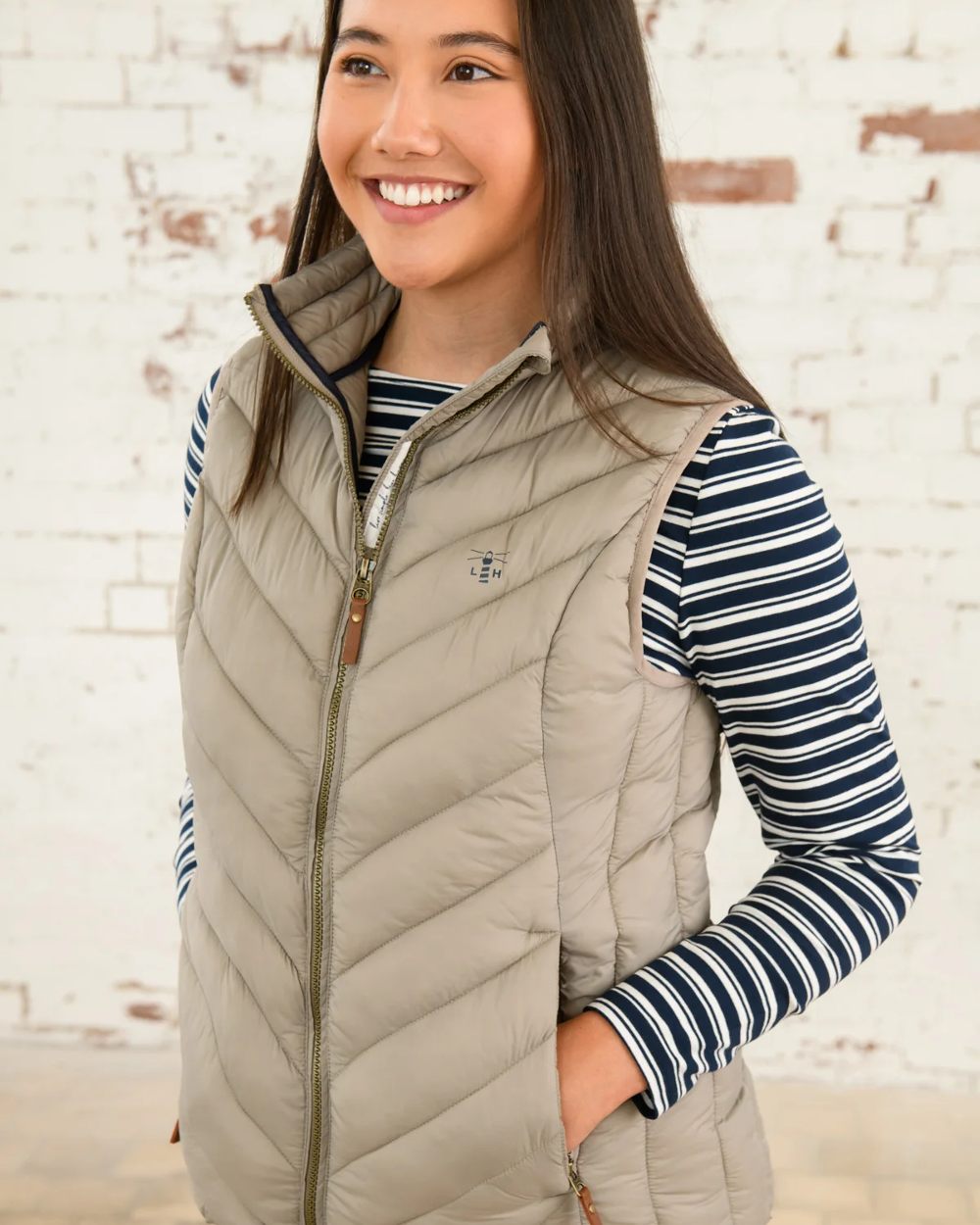 Mocha coloured Lighthouse Laurel Ladies Gilet on wall background