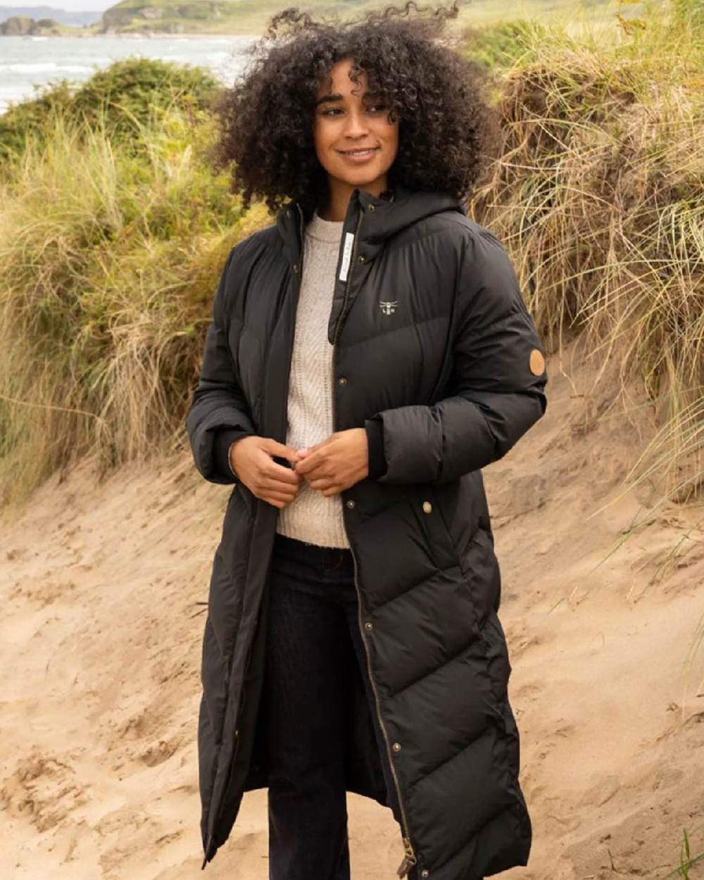 Black coloured Lighthouse Savannah Coat on beach background