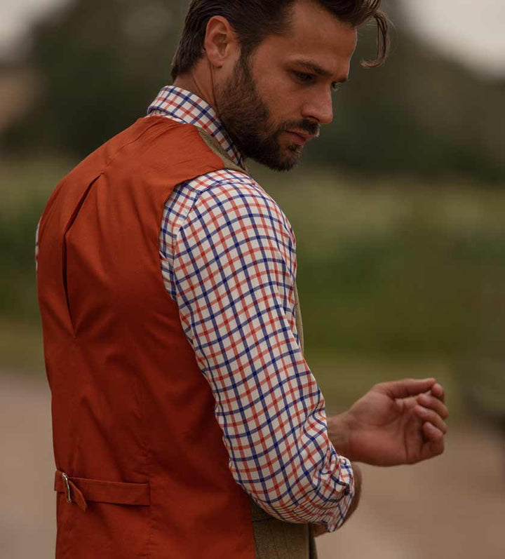 Men's Long sleeve country shirts. Man wears Blue and orange tattersall check shirt.