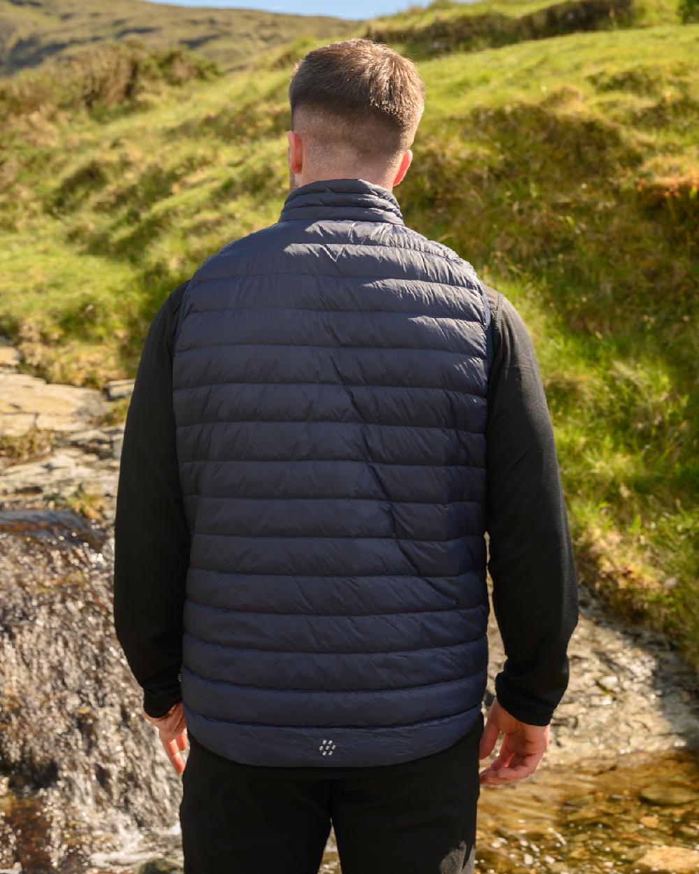 Navy Coloured Mac In A Sac Mens Alpine Down Gilet on mountain background