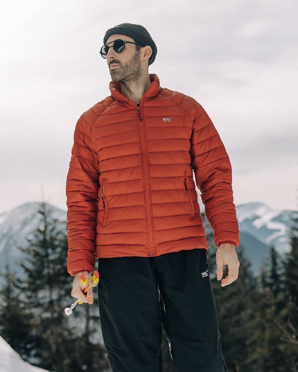 Burnt Orange Coloured Mac In A Sac Mens Synergy Jacket on mountain background