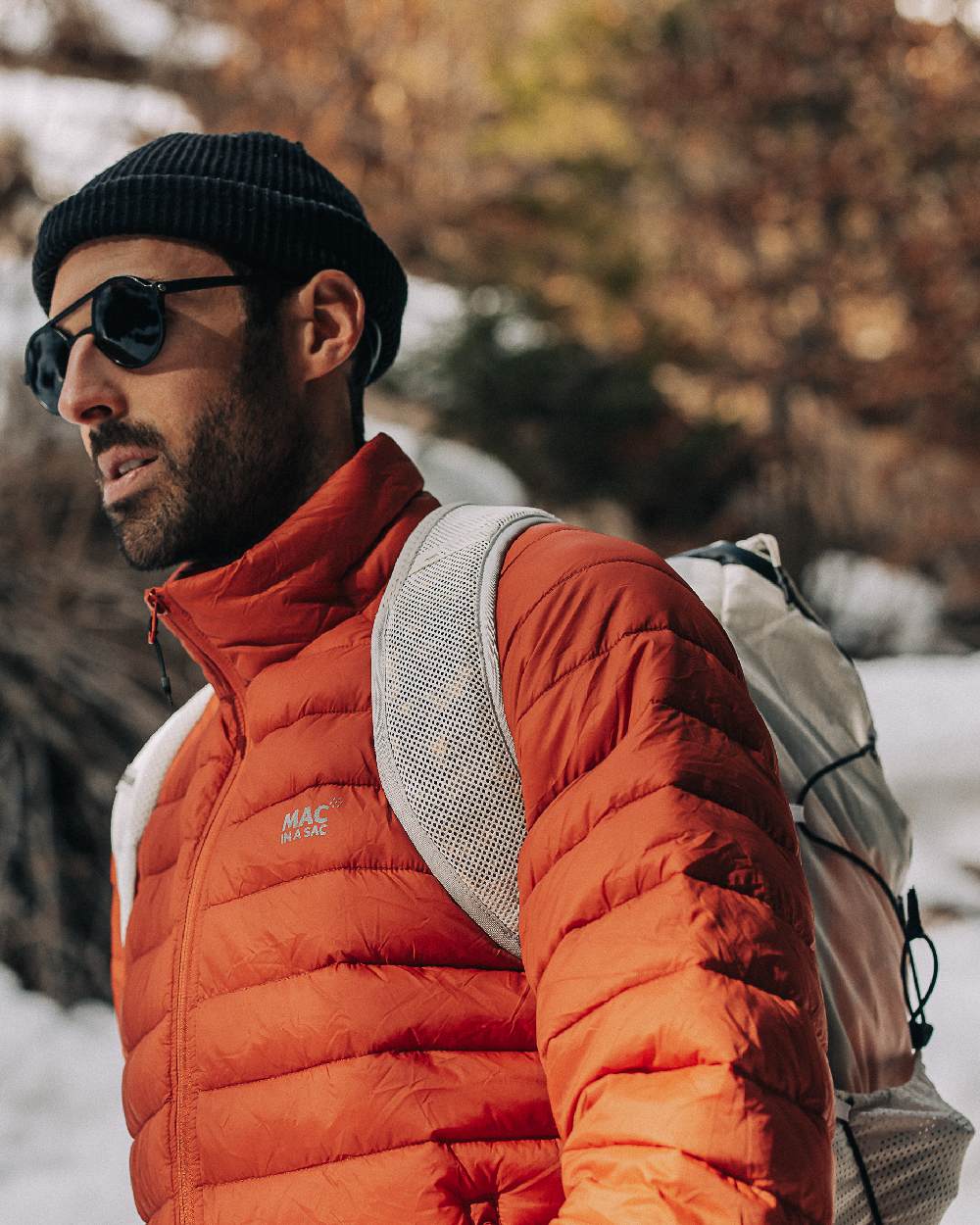 Burnt Orange Coloured Mac In A Sac Mens Synergy Jacket on blurry background