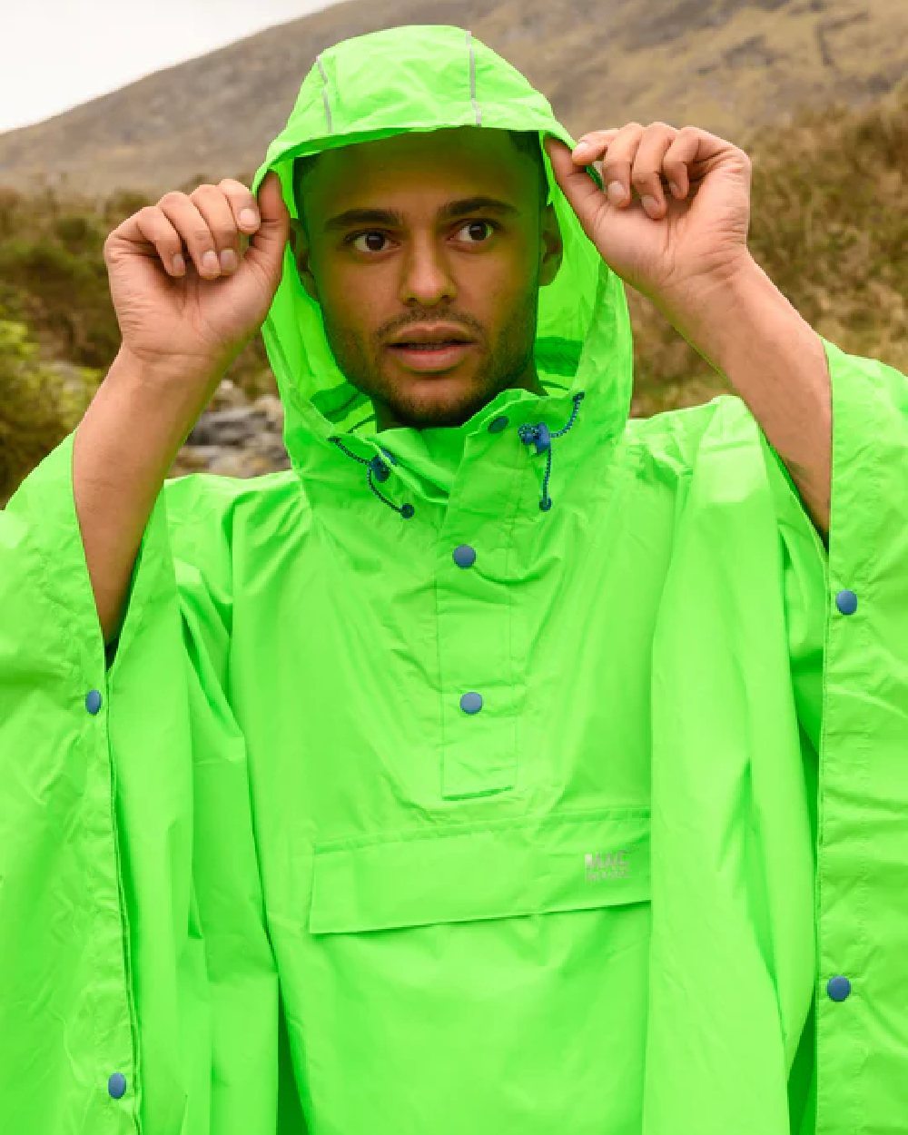 Neon Green Coloured Mac In A Sac Origin Waterproof Poncho Neon on blurry background