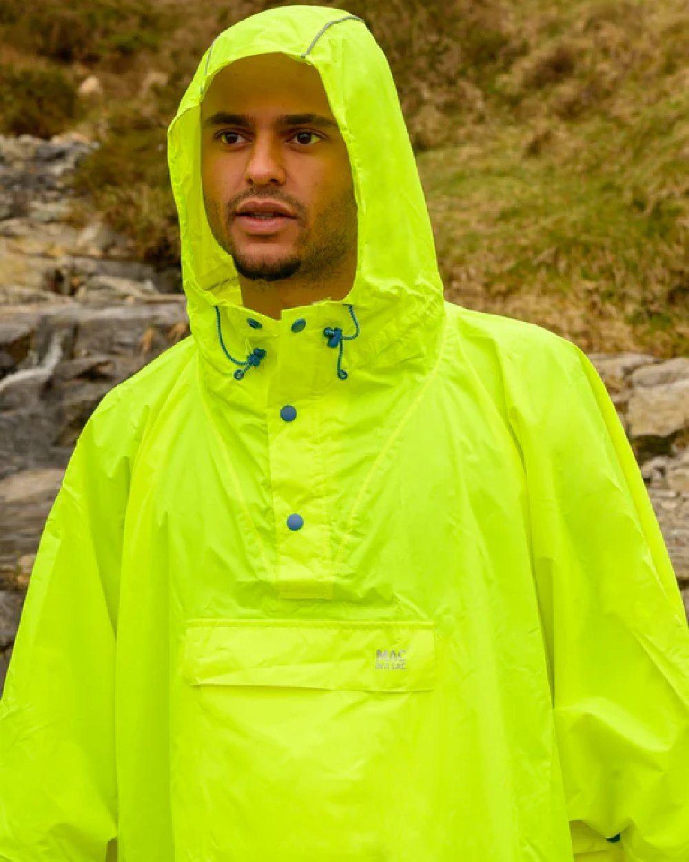 Neon Yellow Coloured Mac In A Sac Origin Waterproof Poncho Neon on blurry background