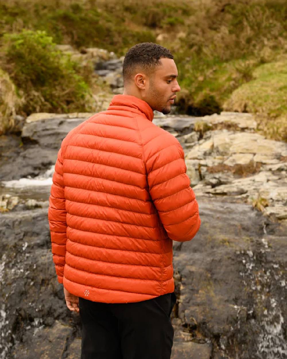 Burnt Orange Grey coloured Mac In A Sac Packable Mens Polar Down Jacket on blurry background