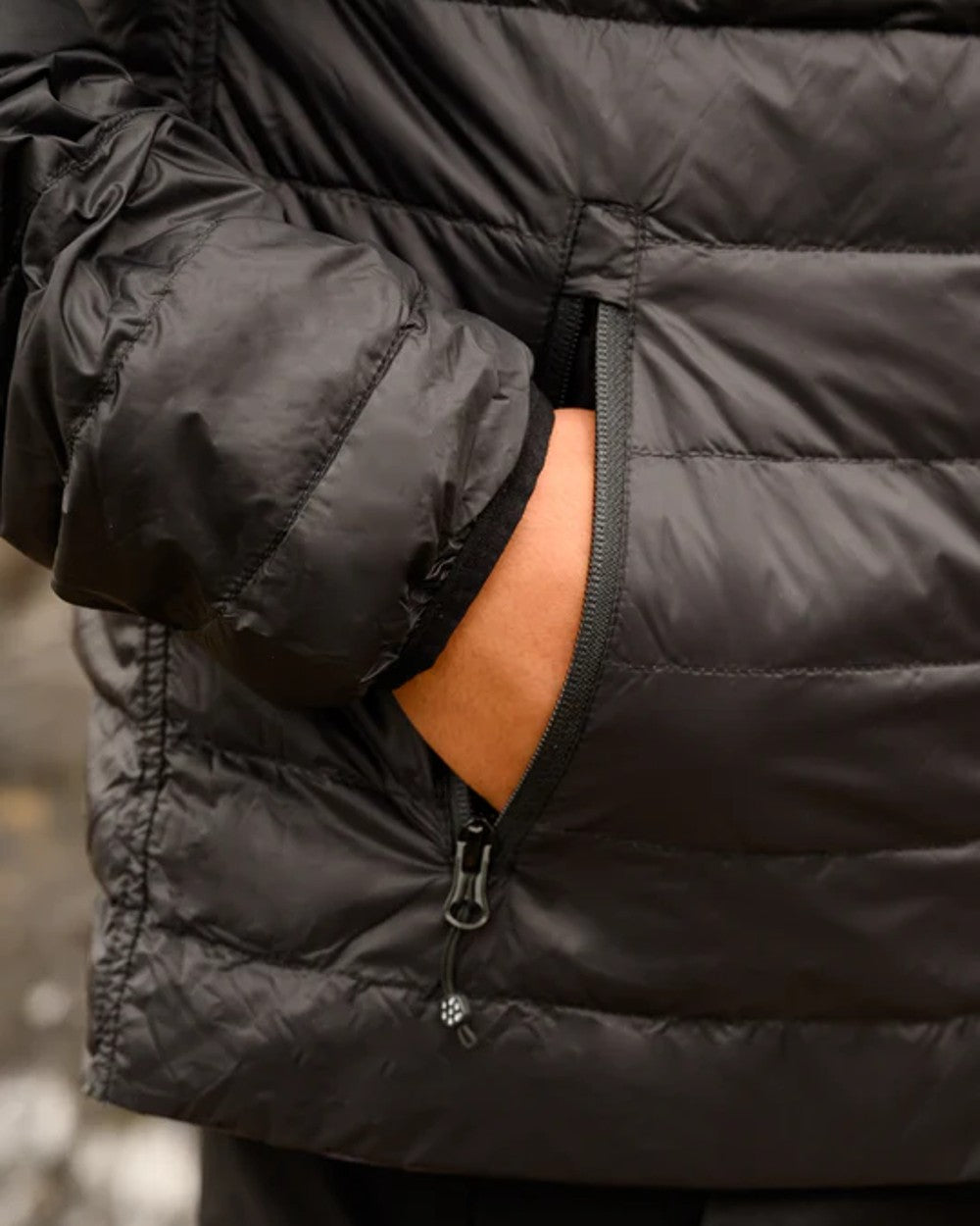 Jet Black Charcoal coloured Mac In A Sac Packable Mens Polar Down Jacket on blurry background
