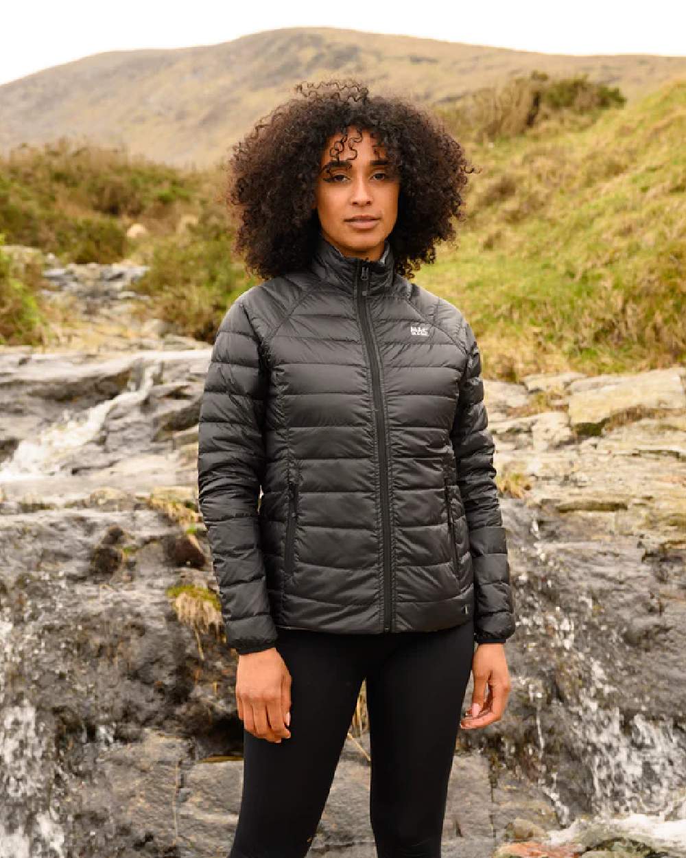 Black Grey coloured Mac In A Sac Packable Womens Down Jacket on blurry background