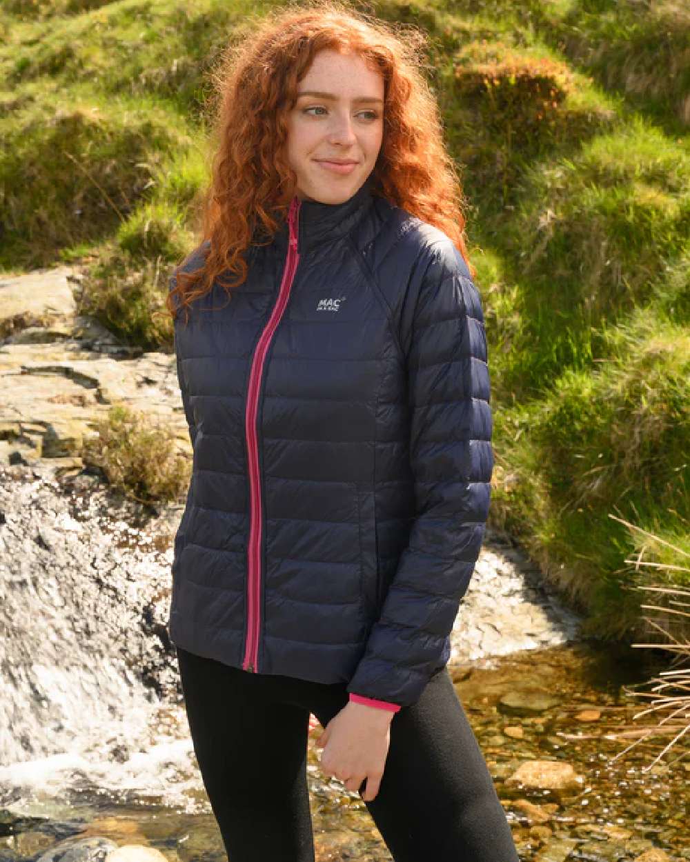 Fuchsia Navy coloured Mac In A Sac Packable Womens Down Jacket on blurry background