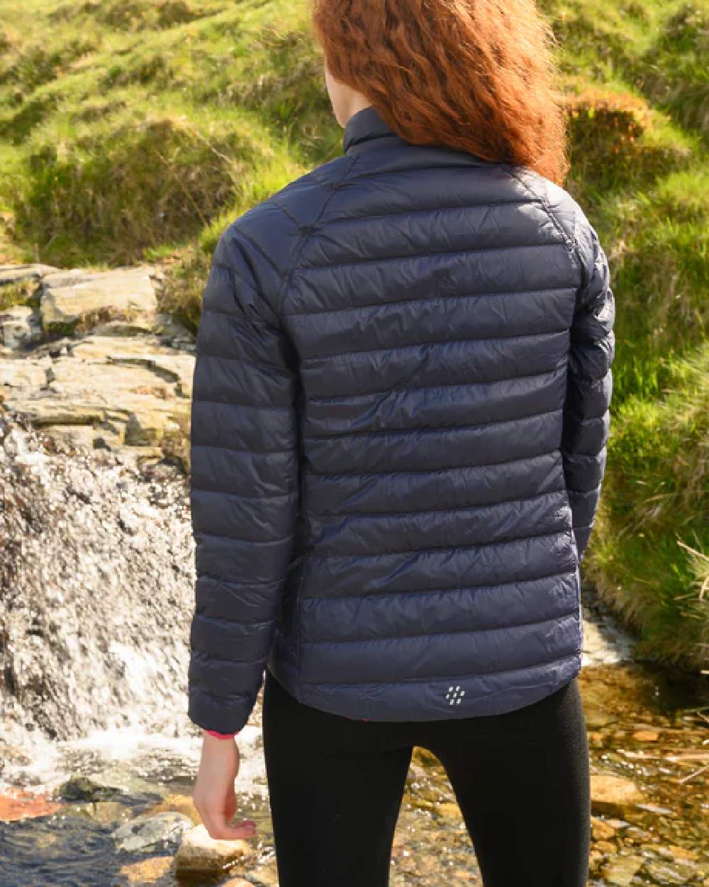 Fuchsia Navy coloured Mac In A Sac Packable Womens Down Jacket on blurry background