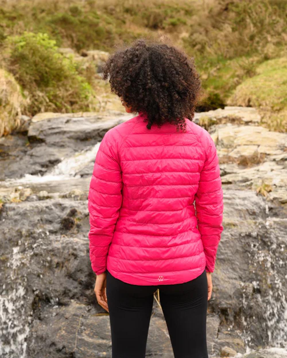 Fuchsia Navy coloured Mac In A Sac Packable Womens Down Jacket on blurry background