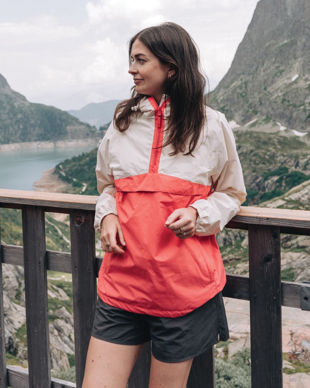 Ivory Poppy coloured Mac In A Sac Womens Nomad Waterproof Half Zip Jacket on mountain background