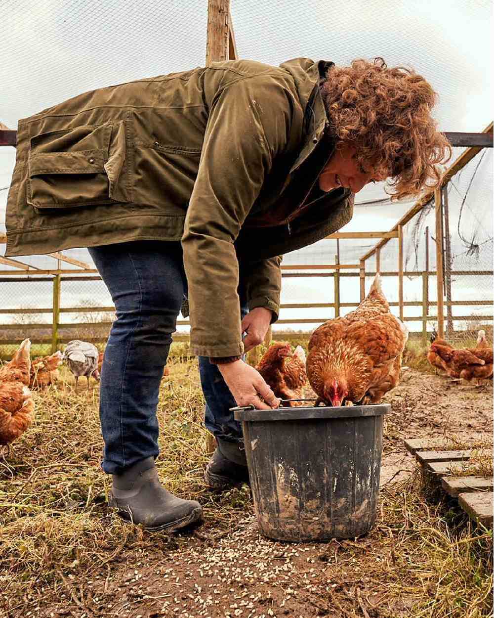 Black Coloured Muck Boots Womens Arctic Sport II Ankle Boots on farm background