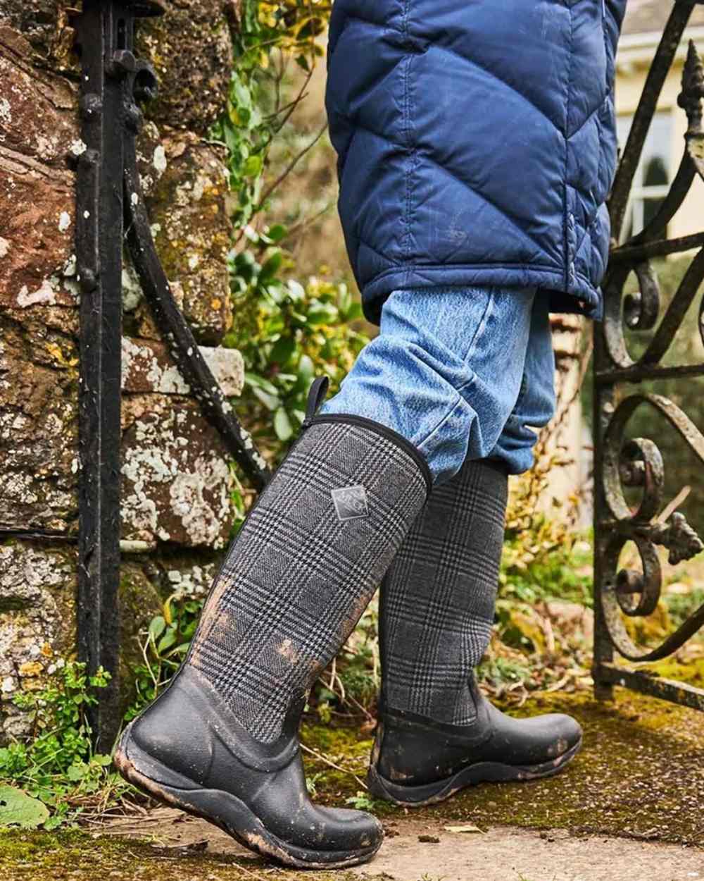 Black Plaid Coloured Muck Boots Womens Arctic Adventure Tall Boots on garden background