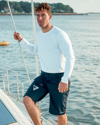 True Navy coloured Musto Br1 Solent Shorts on sea background 