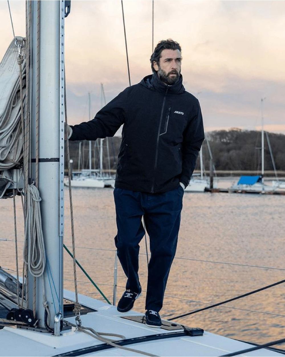 True Navy coloured Musto Mens BR1 Primaloft Midlayer Jacket on yatch background
