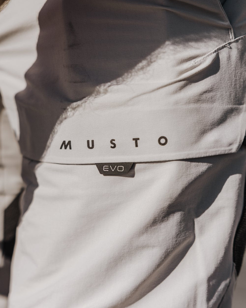 Platinum Coloured Musto Mens Evo Performance Stretch Shorts on outdoor background