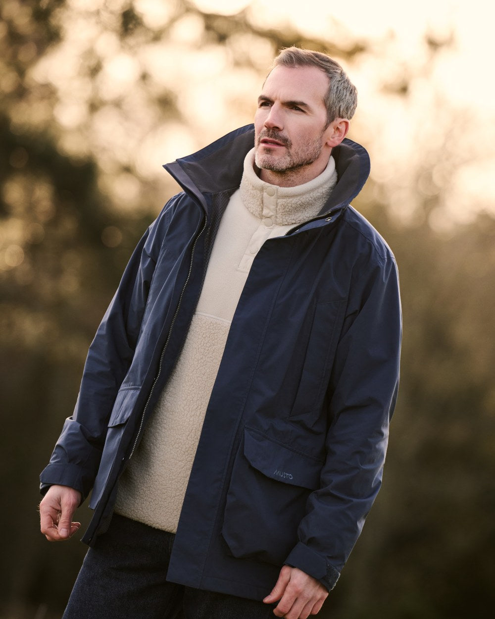 Navy Coloured Musto Mens Fenland Jacket 3.0 on country Background