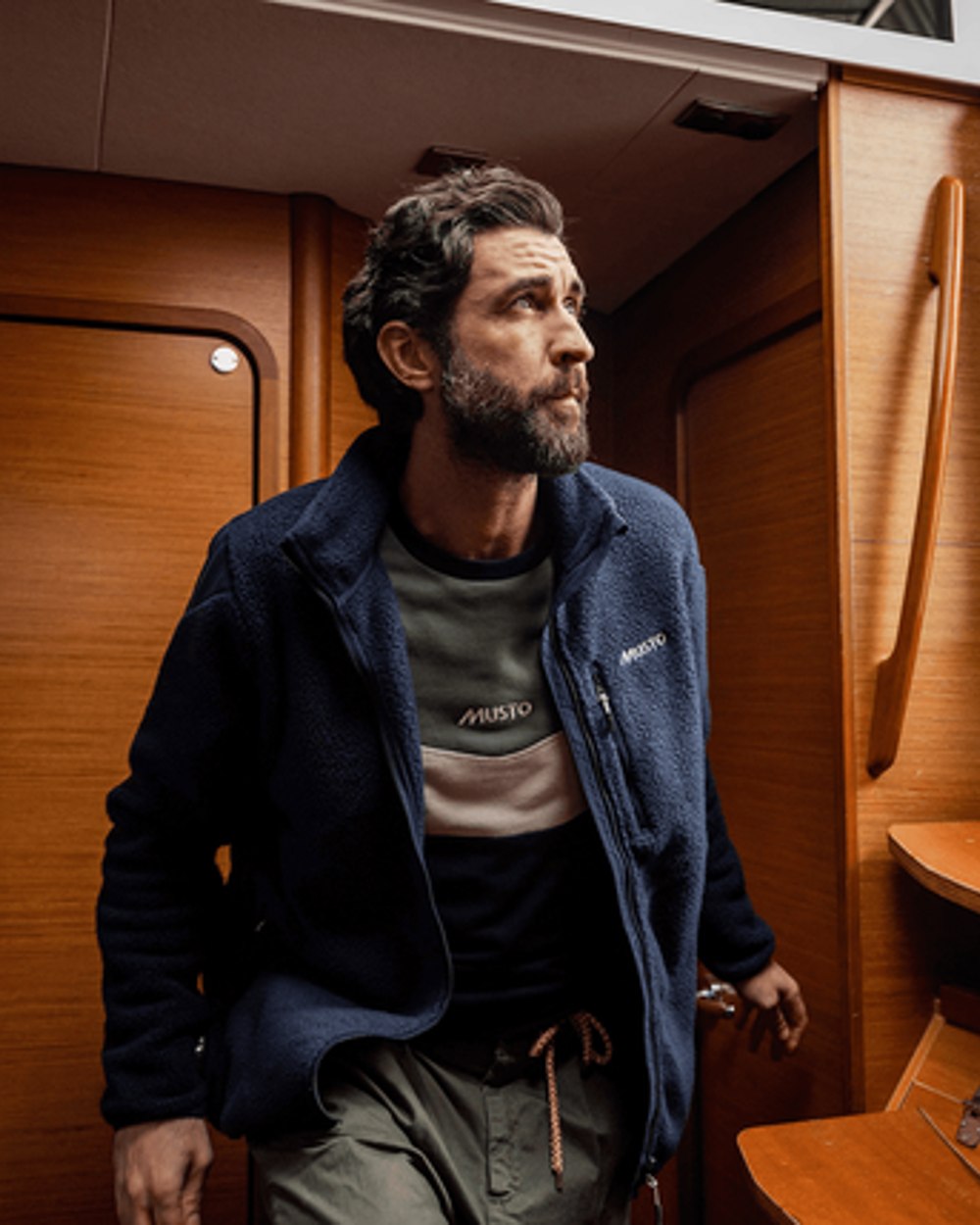 Navy Coloured Musto Mens Nautic Full Zip Pile Fleece on cabin background