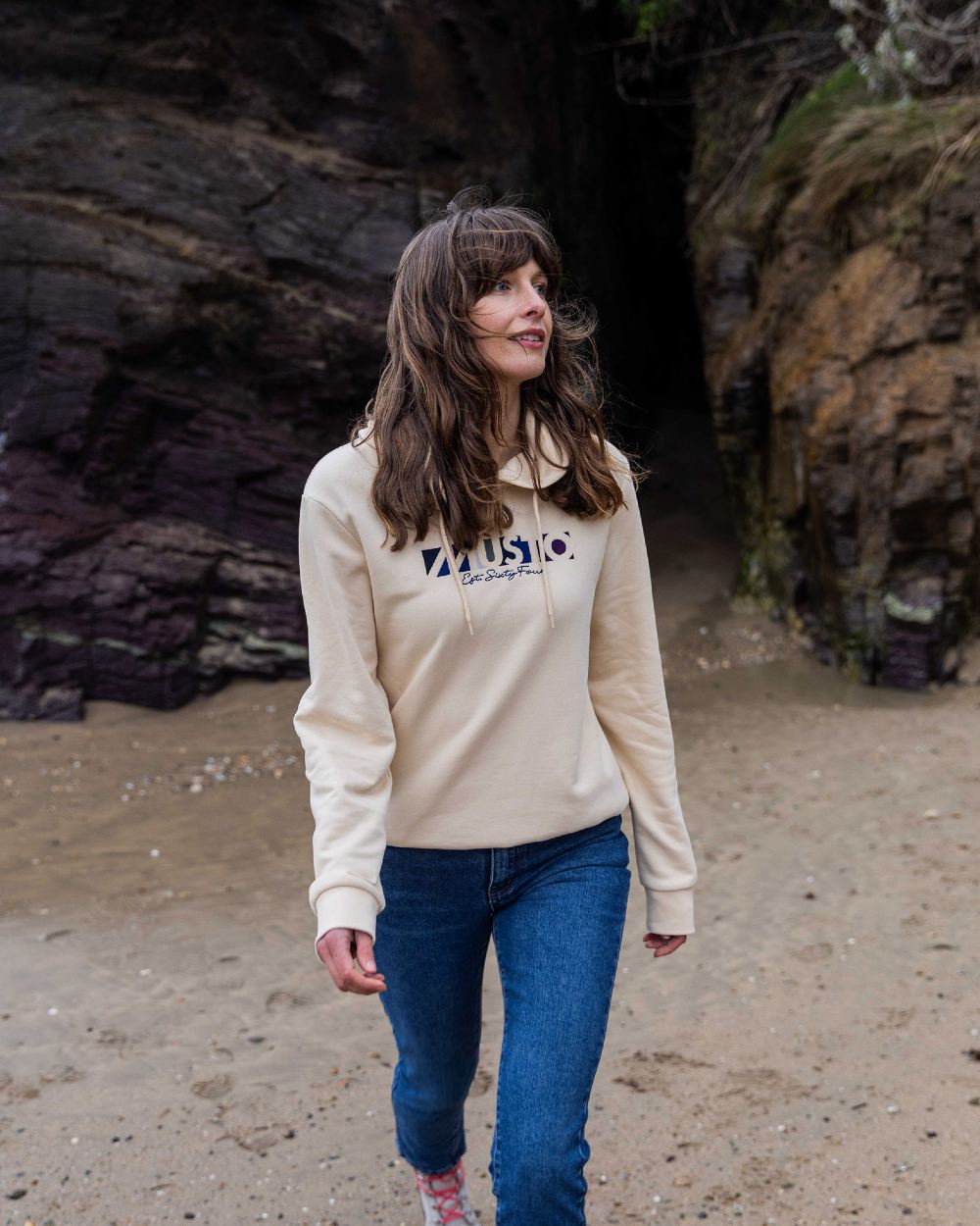 Oat Coloured Musto Womens 1964 Hoodie On A Beach Background