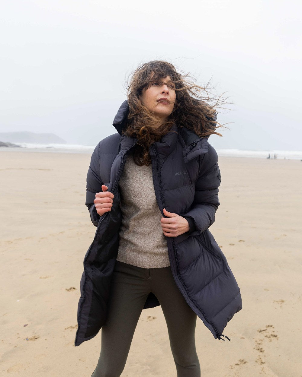 Carbon Coloured Musto Womens Active Puffer Coat on beach background