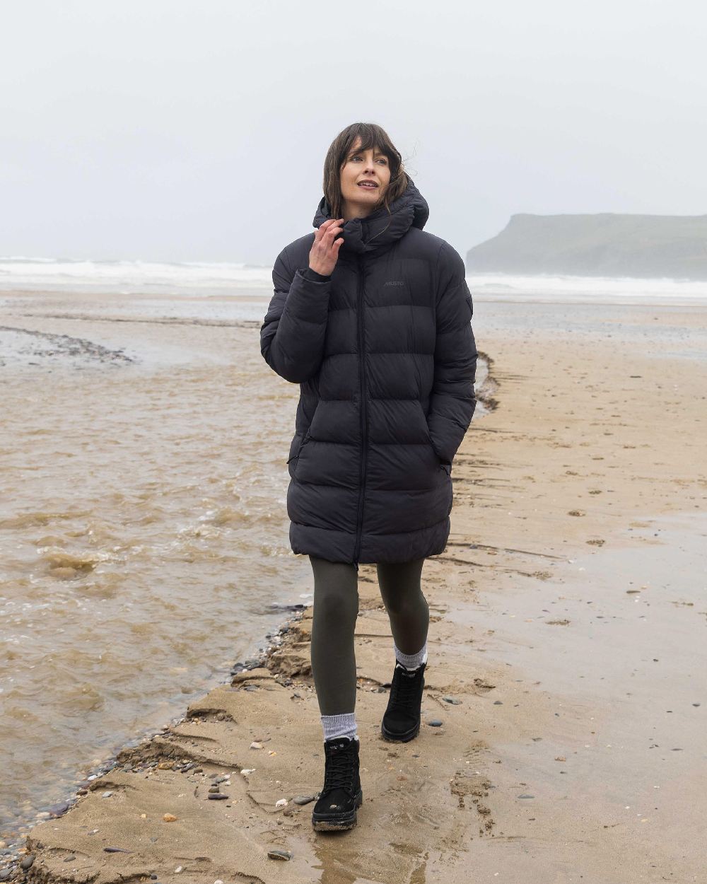 Carbon Coloured Musto Womens Active Puffer Coat on beach background
