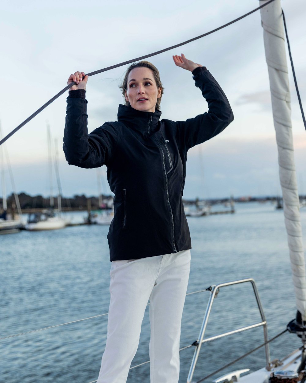 Black Coloured Musto Womens Br1 Primaloft Midlayer Jacket on ocean background