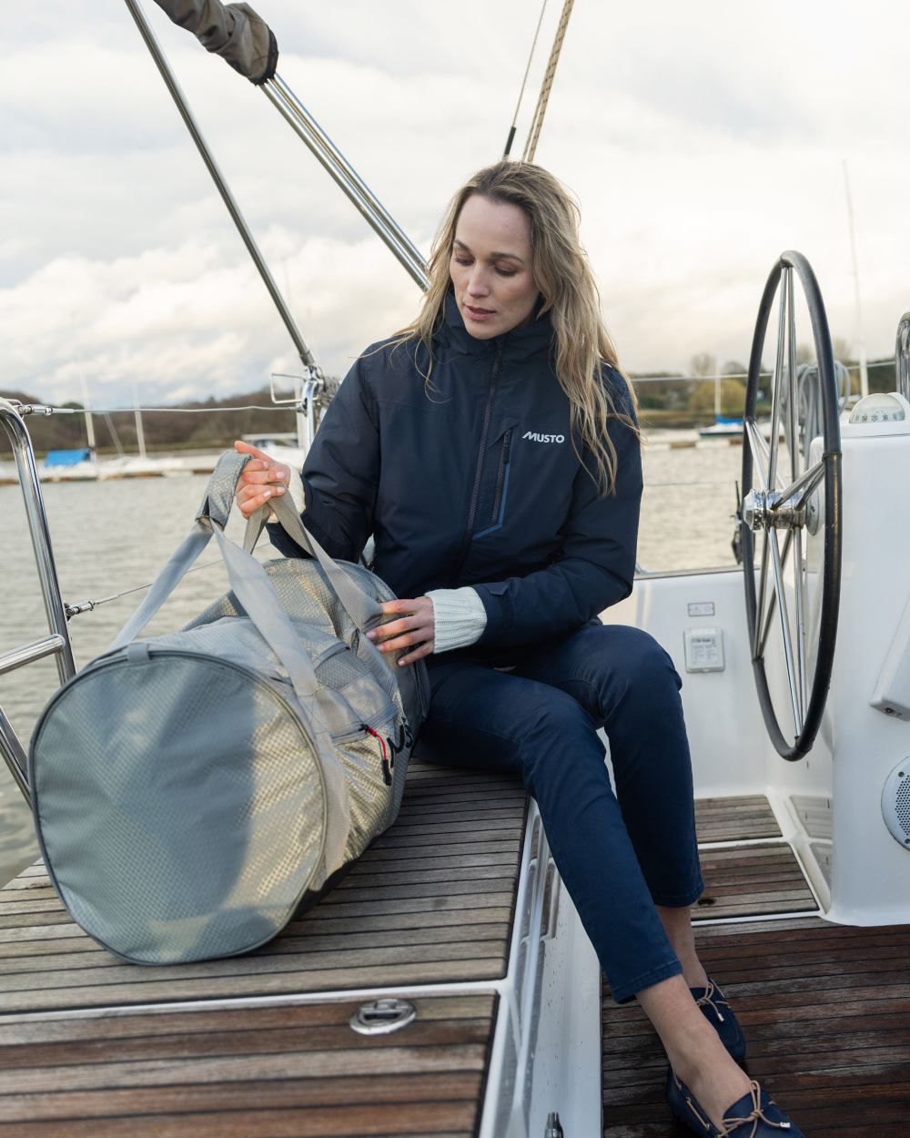 True Navy Coloured Musto Womens Br1 Primaloft Midlayer Jacket on yatch background