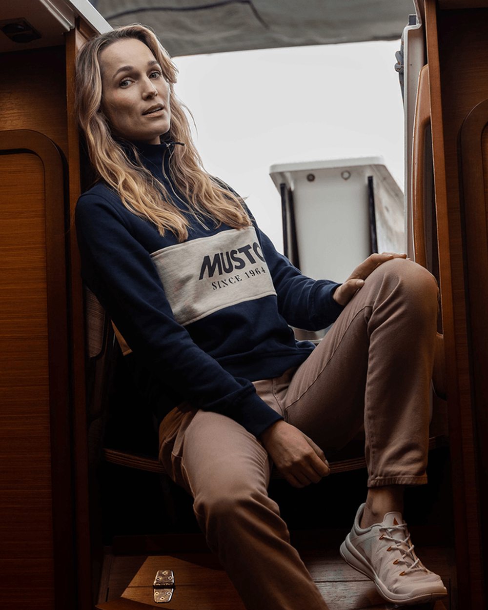 Navy Oat Coloured Musto Womens Classic Half Zip Sweatshirt On A Cabin Background
