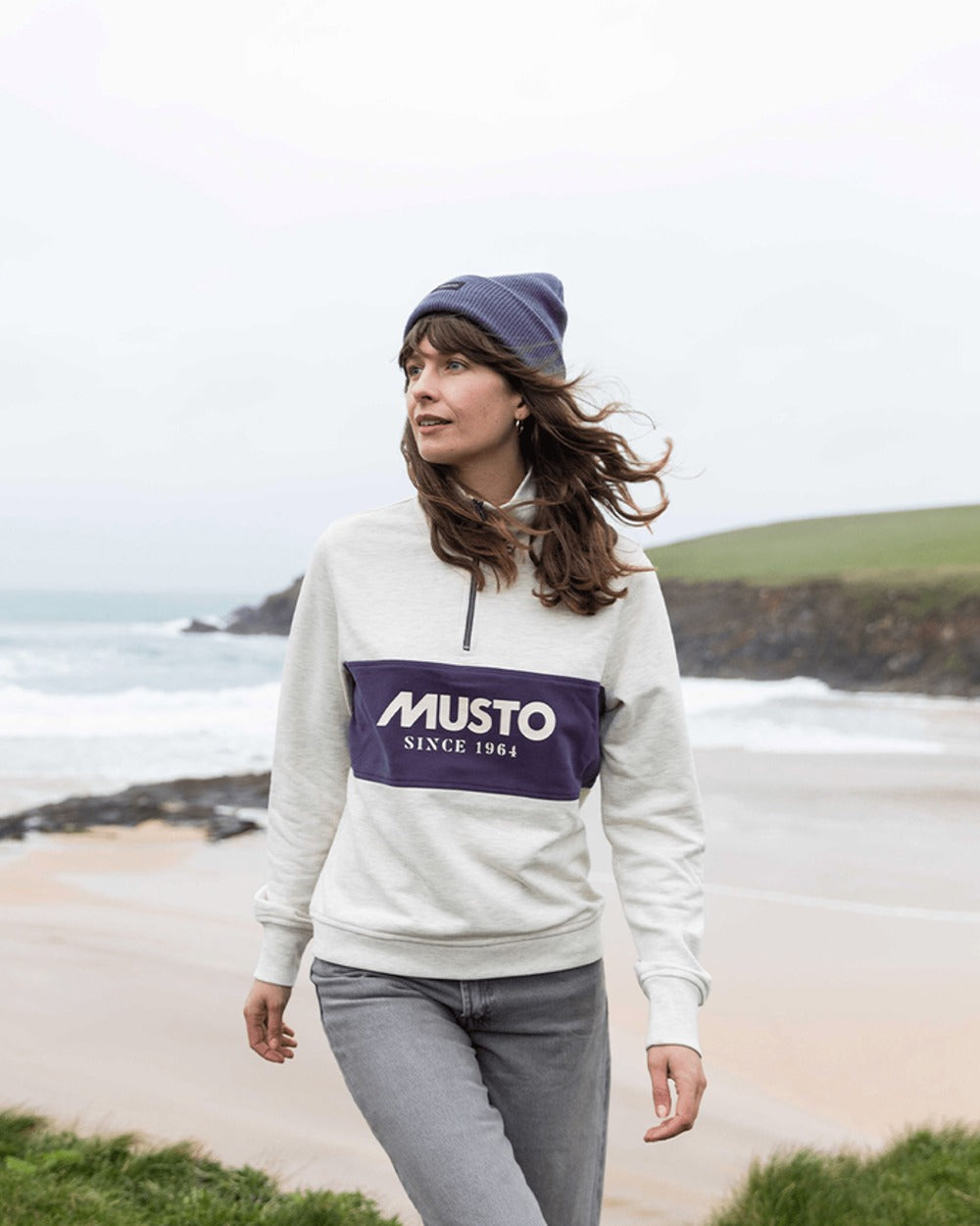 Oat Marl Coloured Musto Womens Classic Half Zip Sweatshirt On A blurry river Background