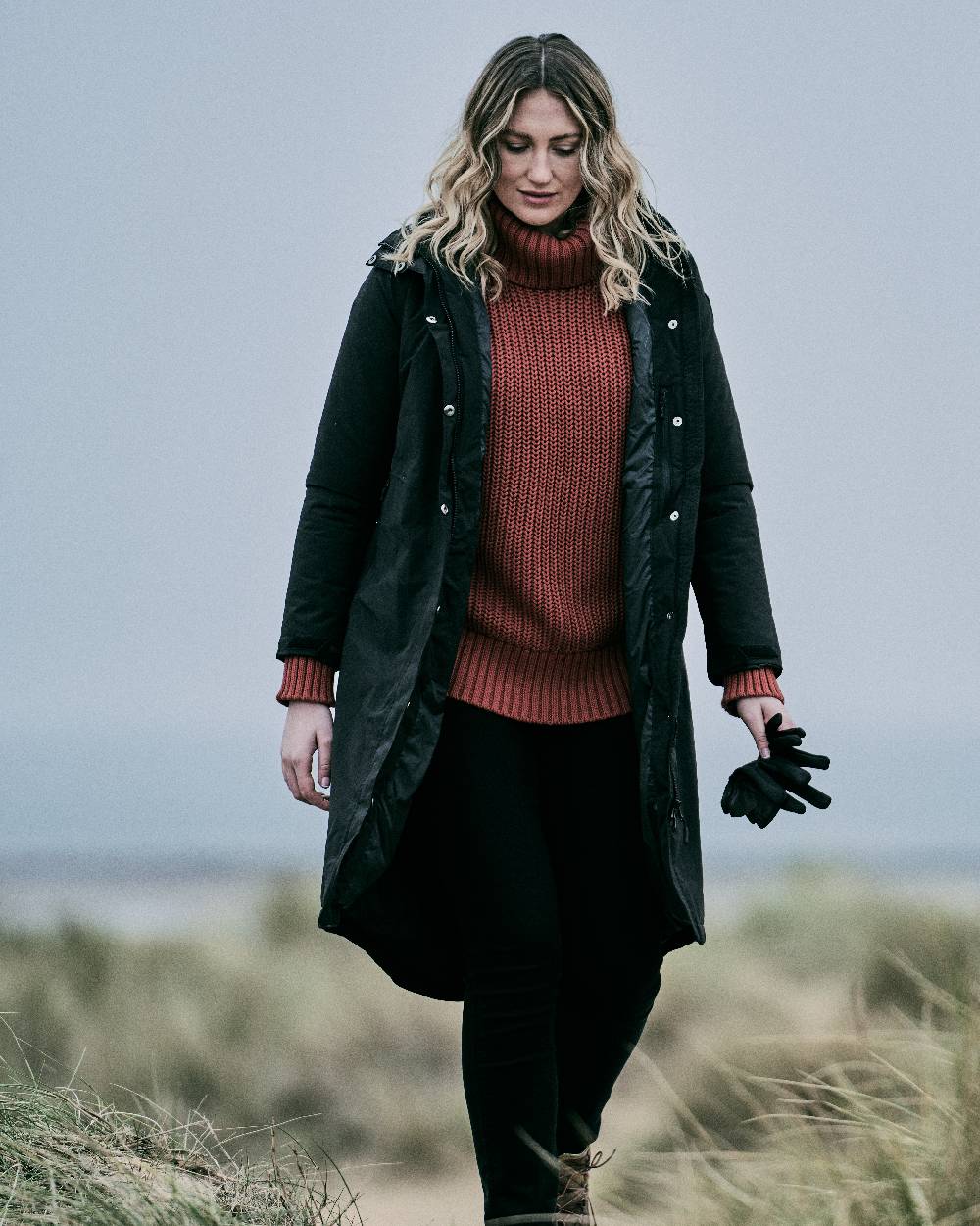 Black coloured Musto Womens Corsica Primaloft Longline Parka on grass background