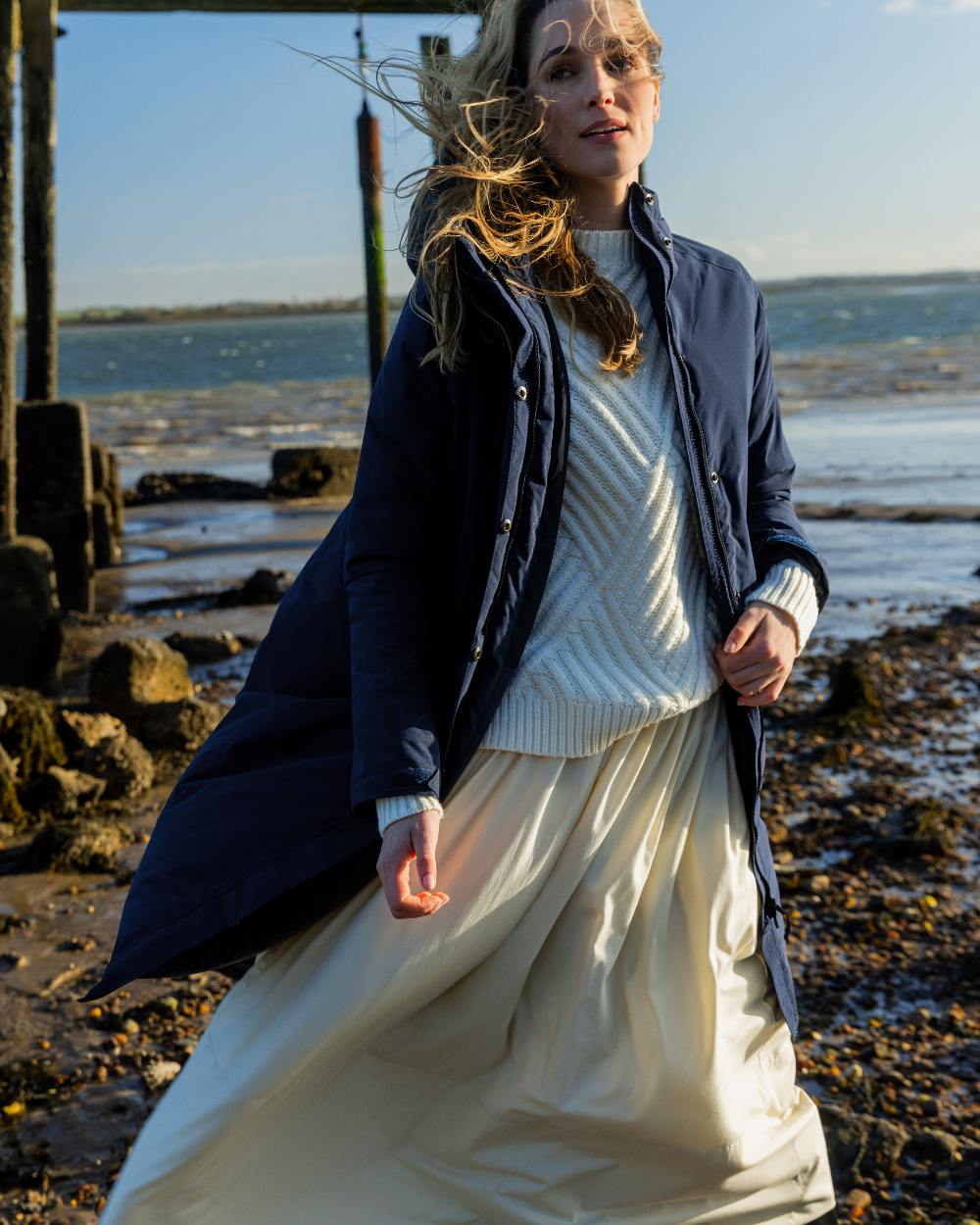 Navy coloured Musto Womens Corsica Primaloft Longline Parka on sea background