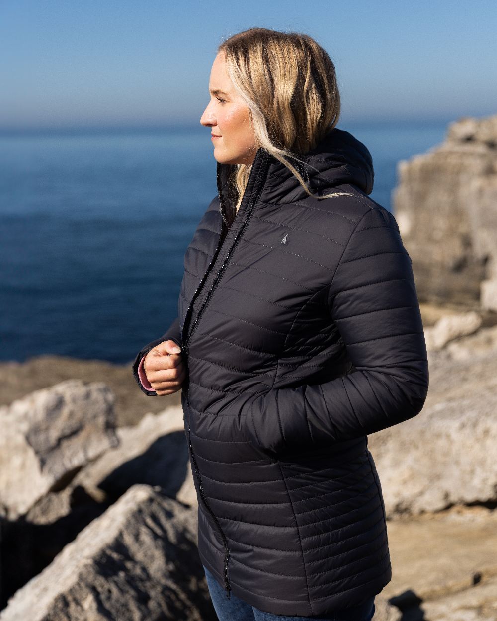 Carbon Coloured Musto Womens Original Lite Puffer Coat on sea background