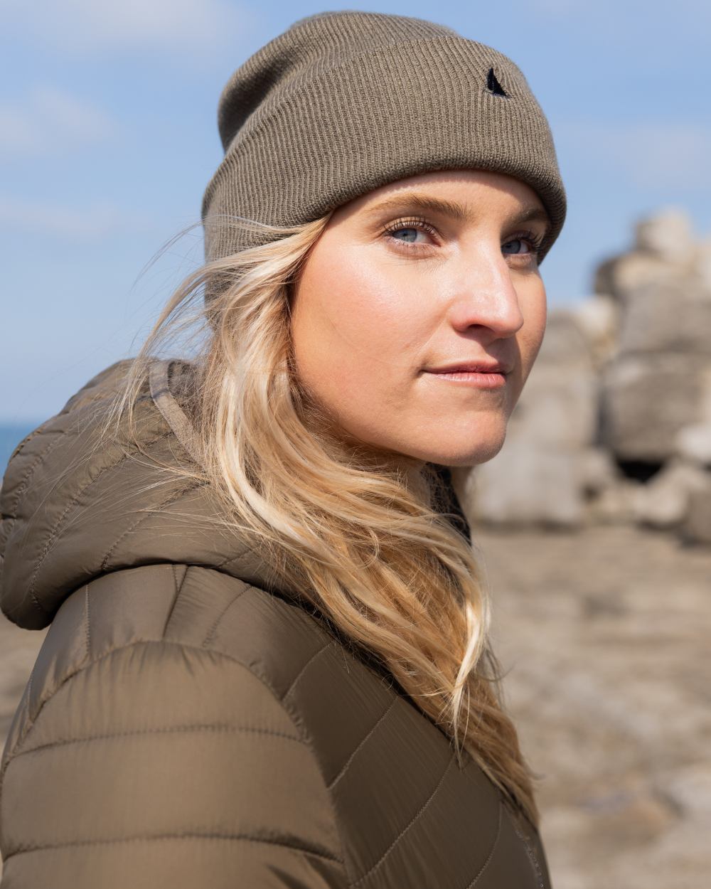 Crocodile Coloured Musto Womens Original Lite Puffer Coat on sea background