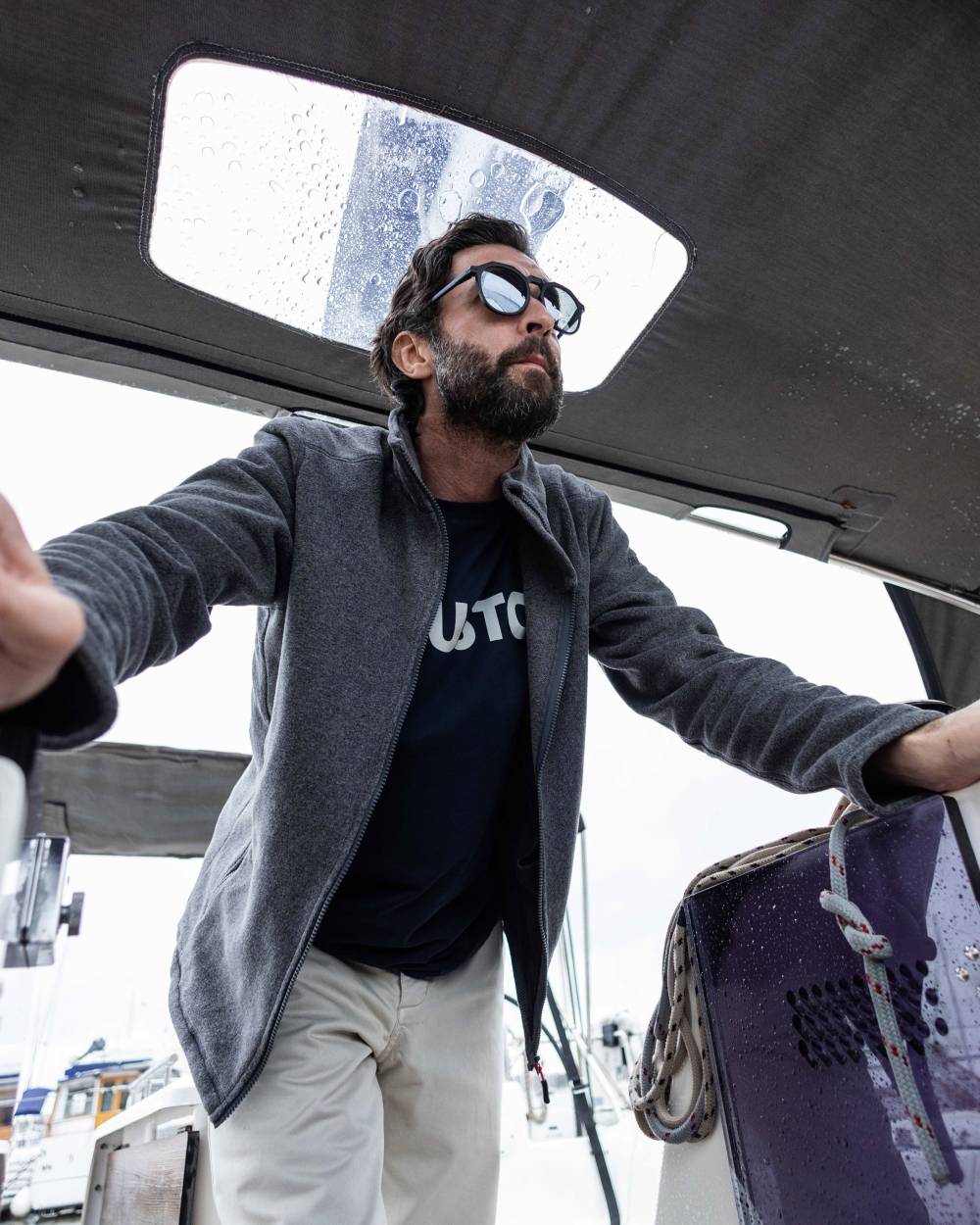 Dark Grey Marl coloured Musto Corsica Polartec 200gm Fleece 2.0 on boat background