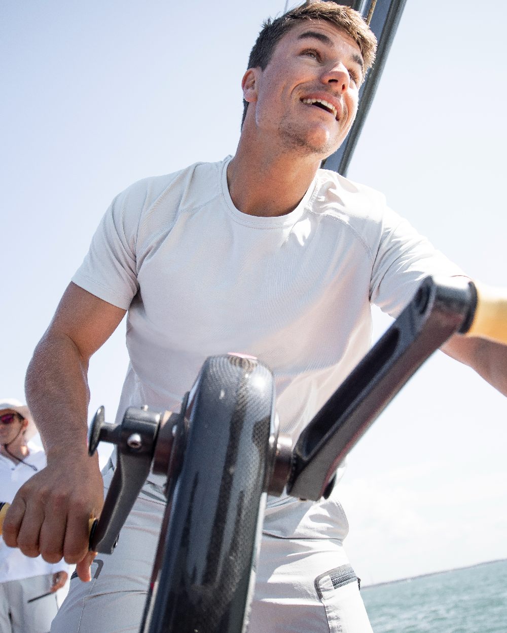 White coloured Musto Mens Sunblock Short Sleeve T-Shirt on Sailing  background 
