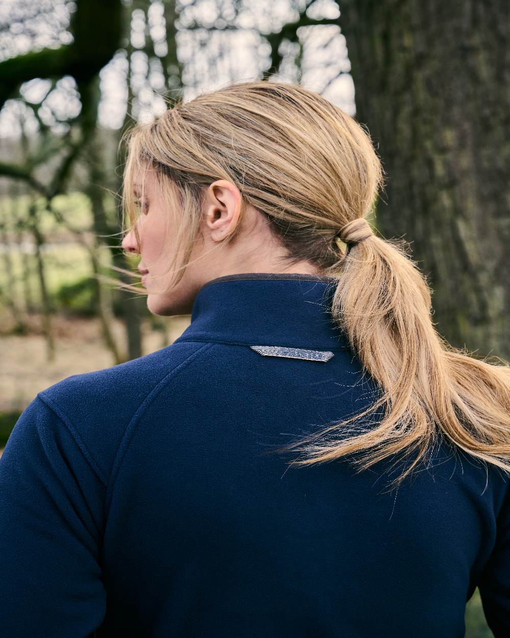 Navy Coloured Musto Womens Fenland 200 Polartec Jacket on Forest Background