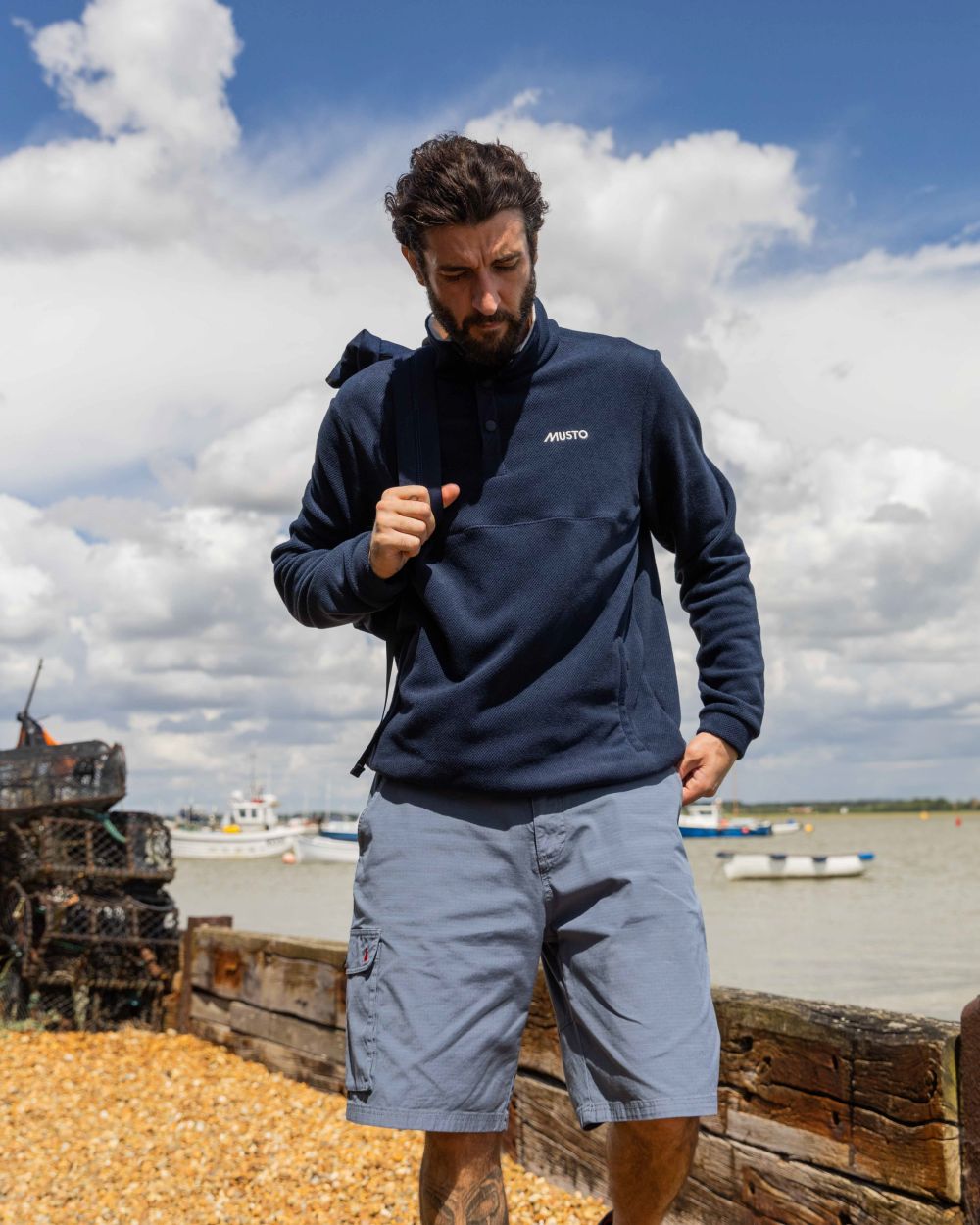 Navy Coloured Musto Mens Classic Fleece Pullover On A Beach Background 