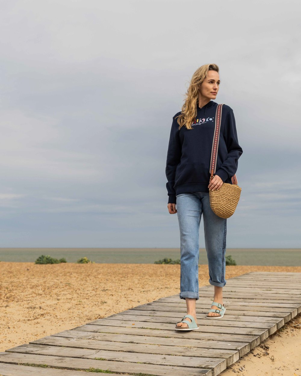 Navy Coloured Musto Womens 1964 Hoodie On A Beach Background