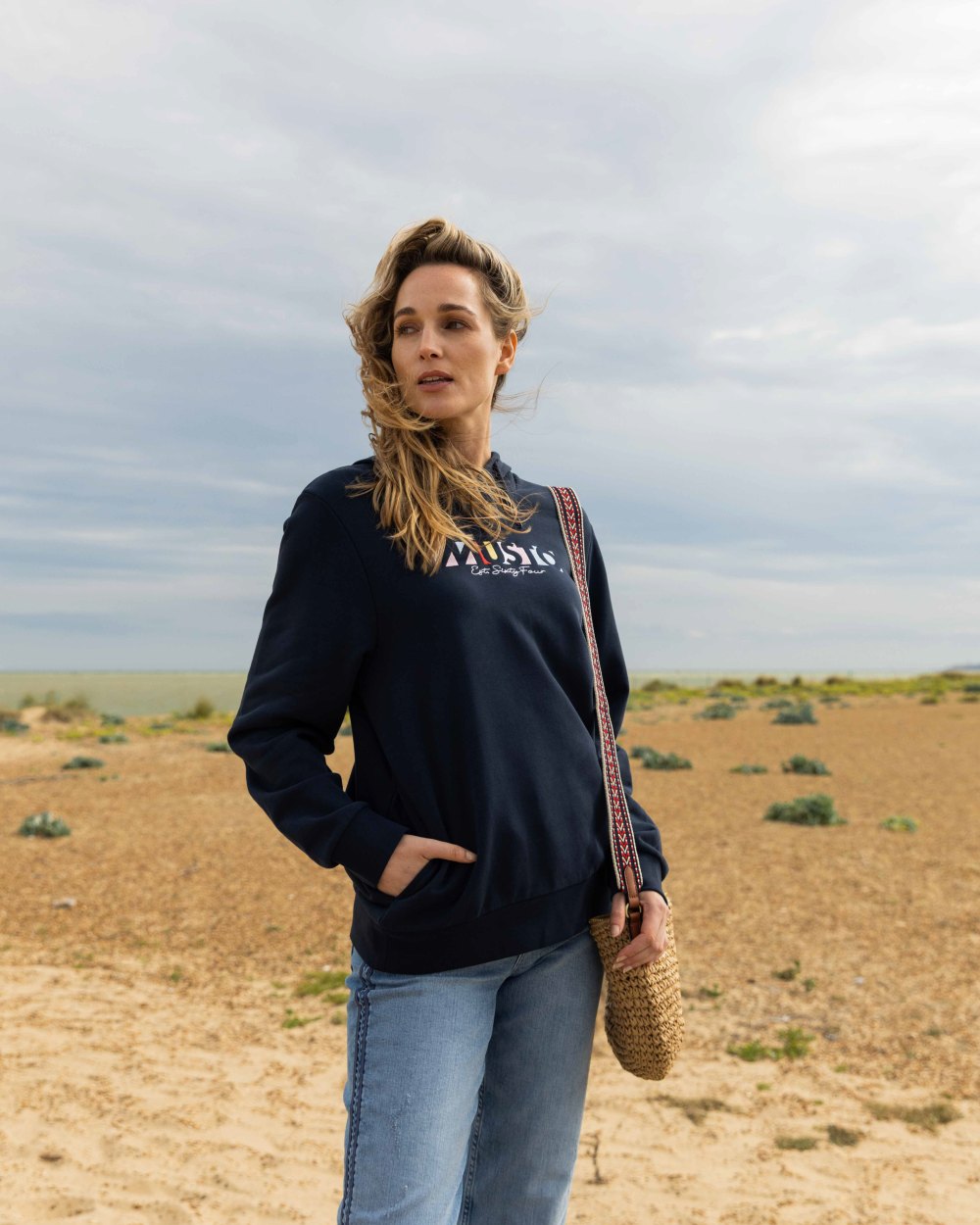Navy Coloured Musto Womens 1964 Hoodie On A Beach Background