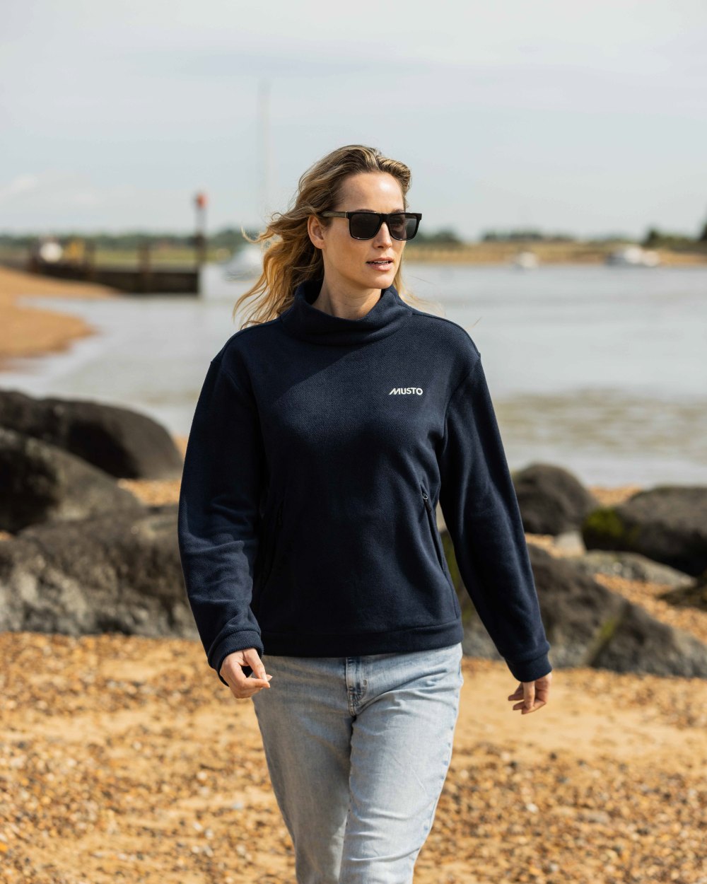 Navy Coloured Musto Womens Classic Fleece Pullover On A Beach Background 