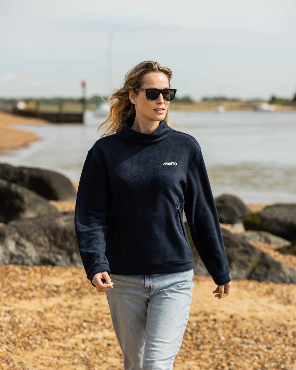 Navy Coloured Musto Womens Classic Fleece Pullover On A Beach Background