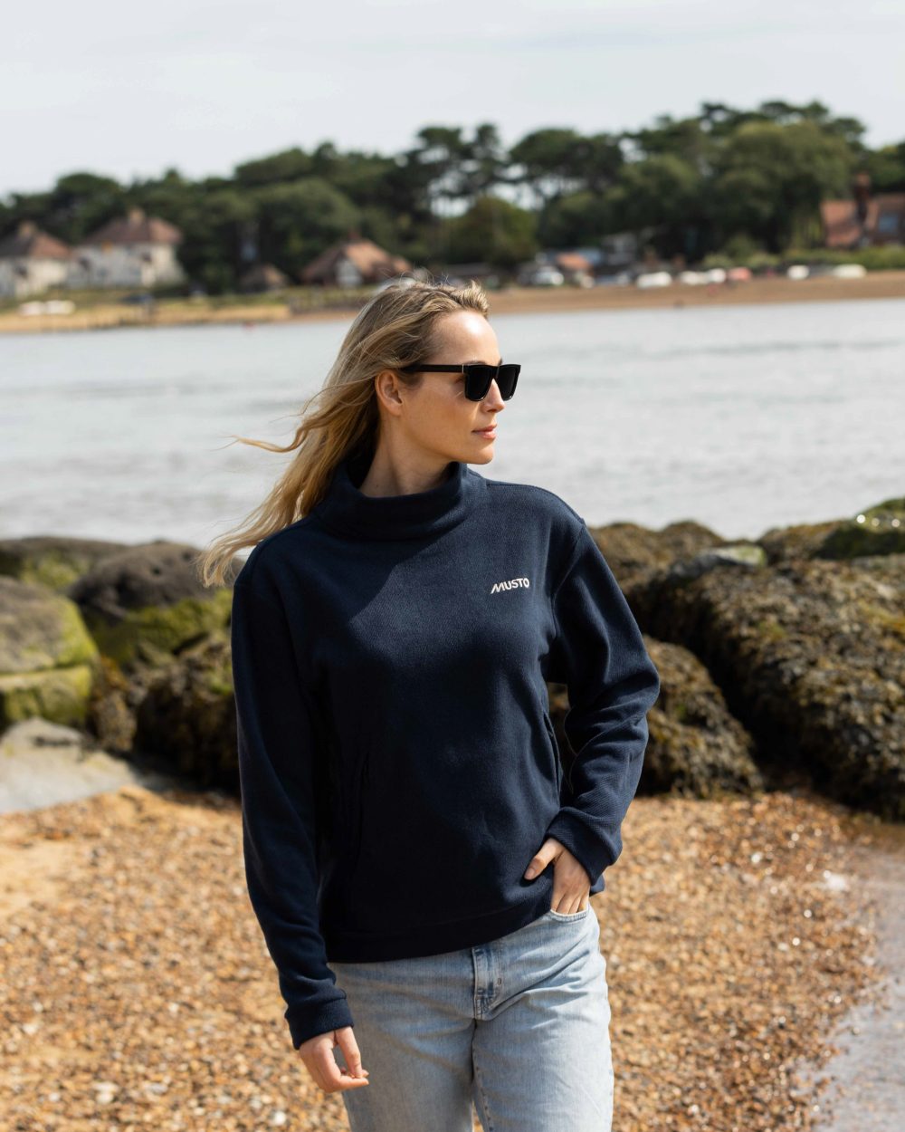 Navy Coloured Musto Womens Classic Fleece Pullover On A Beach Background