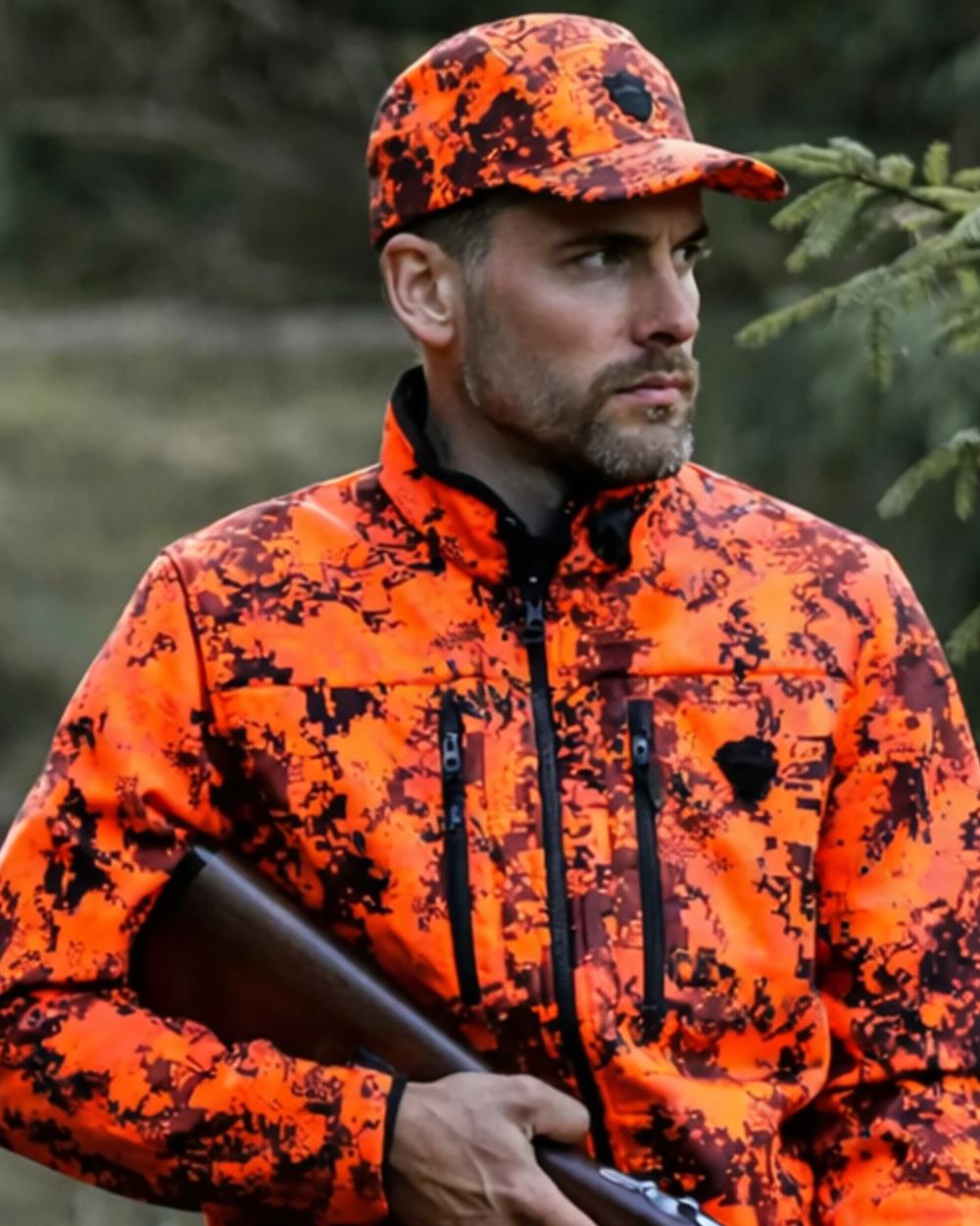 Camo Orange Blaze coloured Northern Hunting Asle Camo Cap on forest background