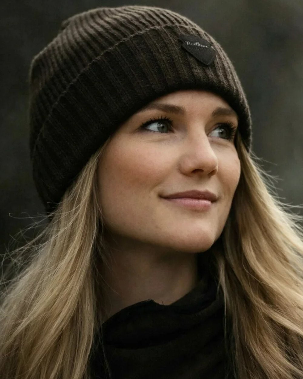 Green coloured Northern Hunting Buk Windstop Beanie on forest background