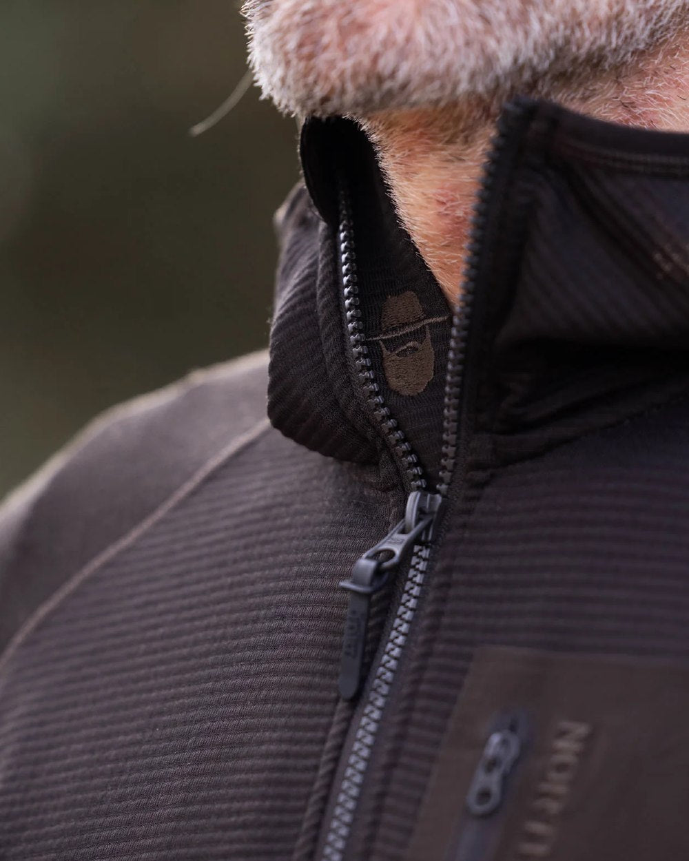 Dark Green coloured Northern Hunting Mens Rolf Half Zip Sweatshirt on blurry background