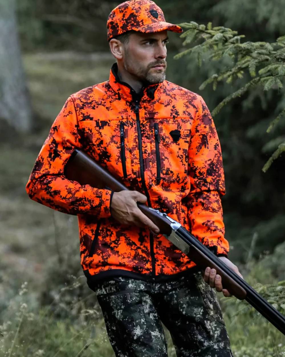 Camo coloured Northern Hunting Mens Skjold Arn G2 Waterproof Hunting Trousers on forest background