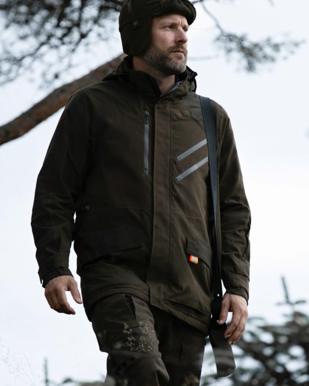 Dark Green coloured Northern Hunting Mens Thor Balder Waterproof Hunting Trousers on forest background